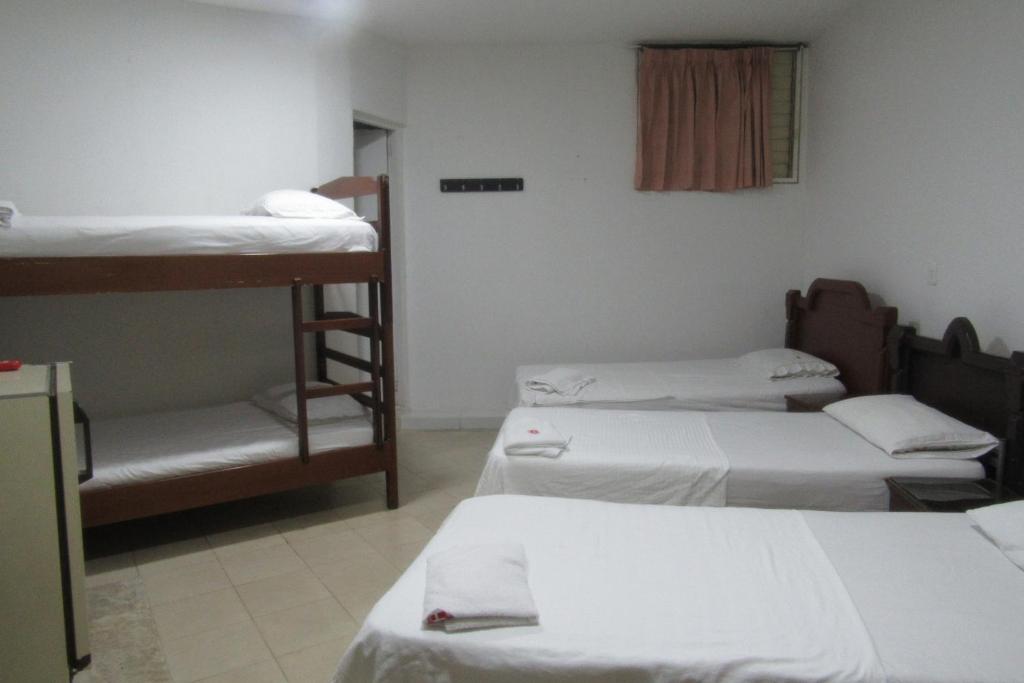 Postel nebo postele na pokoji v ubytování Hotel Nuevo Tio