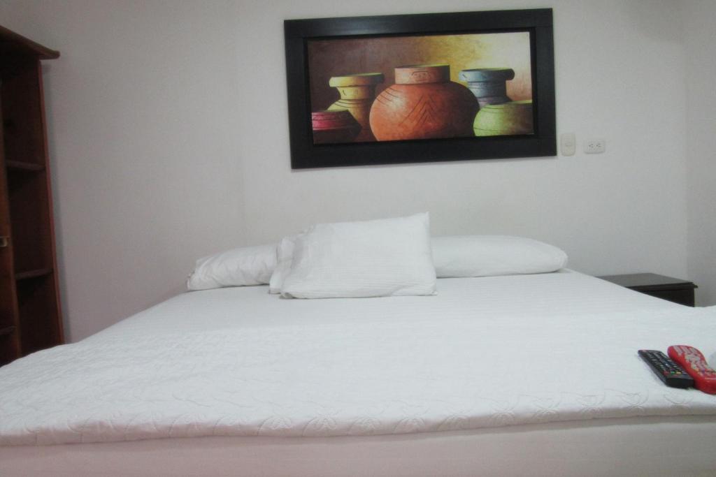 Postel nebo postele na pokoji v ubytování Hotel Nuevo Tio