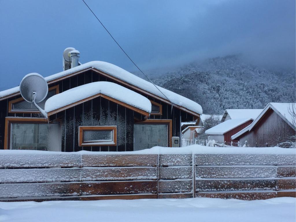 a house with snow on the roof at Refugio Simple Sur Casa 4 personas in Malalcahuello