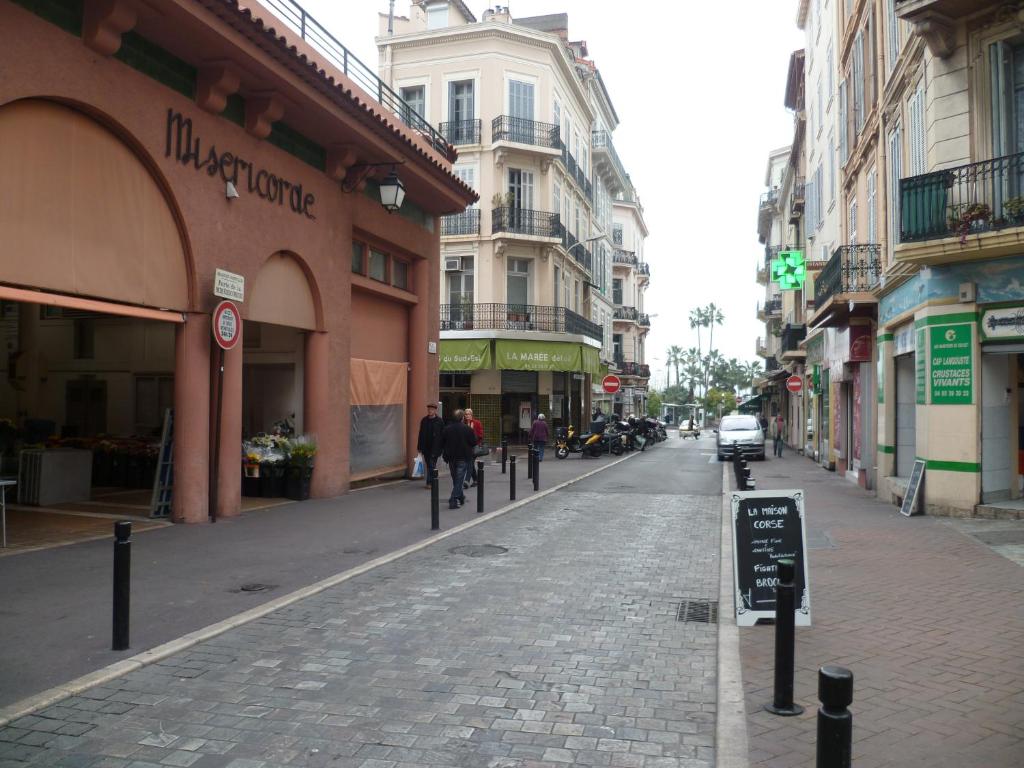 a cobblestone street in a city with buildings at Karolina Properties - Misericorde Appartements in Cannes