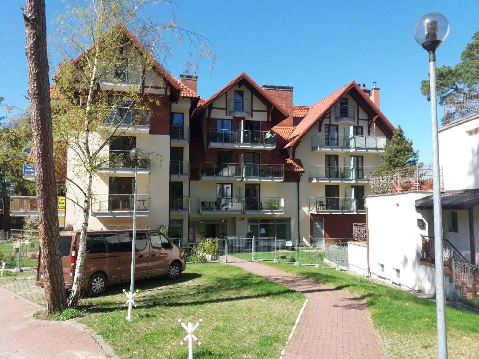 クリニツァ・モルスカにあるNowa Apartamenty Apartament Słoneczny Bulwarの車が向かいに停まった建物