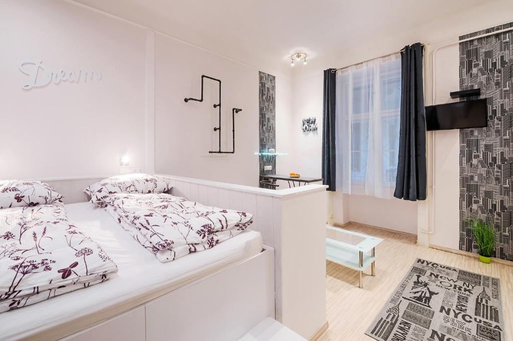 a white bedroom with a bed and a window at FREE PARKING, QUIET design flat in the centre in Budapest