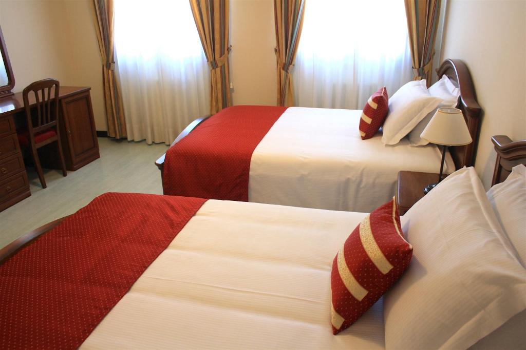 Postel nebo postele na pokoji v ubytování Albergo Italia