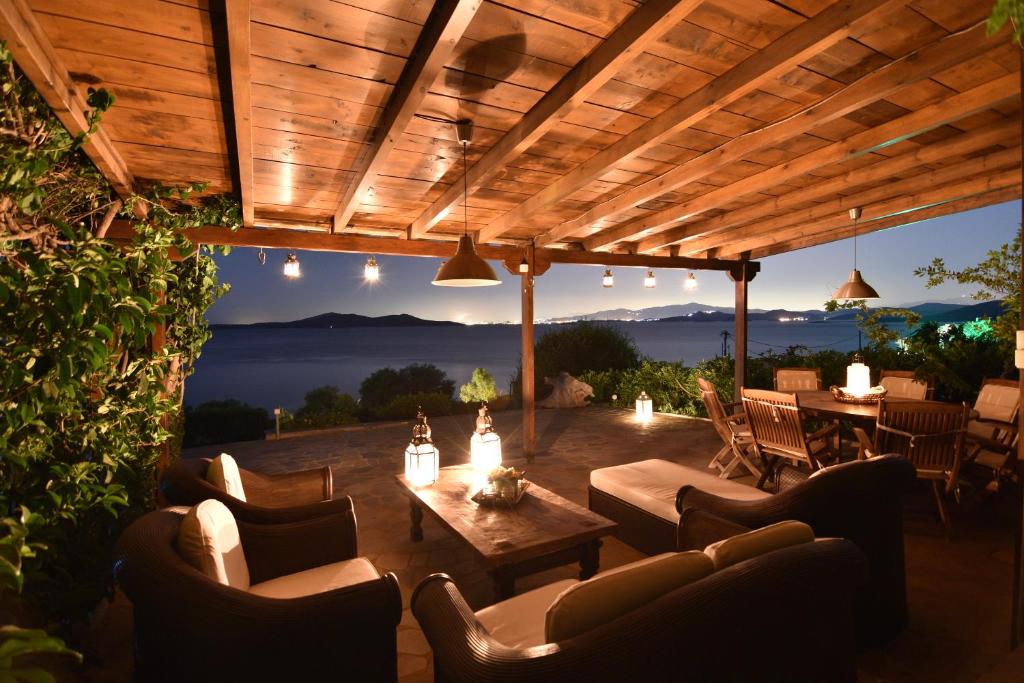 a patio with couches and a table and chairs at Blue Bay View - Beach House in Diliso