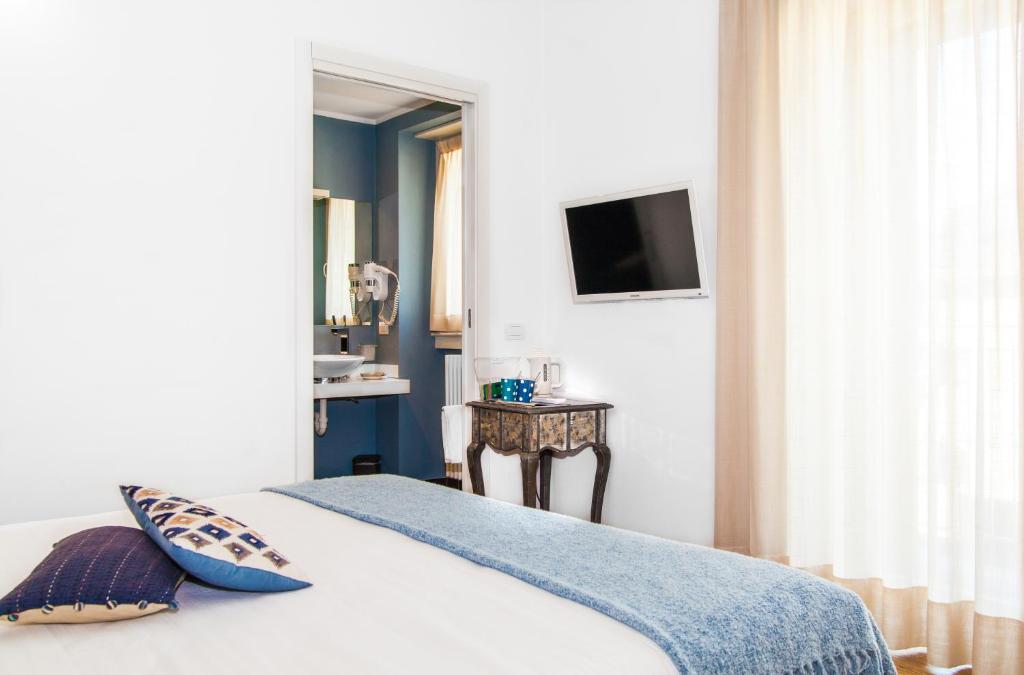 Postel nebo postele na pokoji v ubytování Spluga Sosta & Hotel