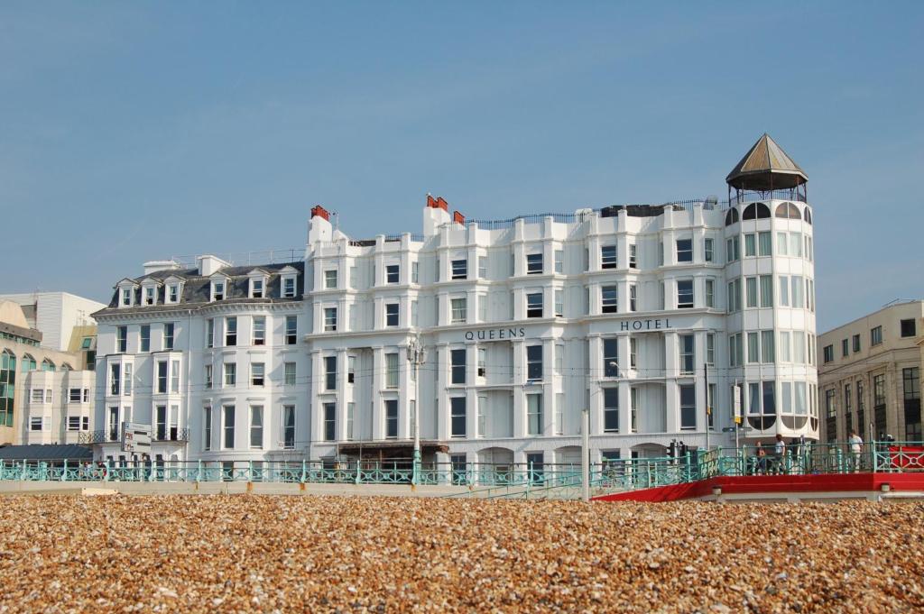 a white building on the beach in front at Queens Hotel & Spa in Brighton & Hove
