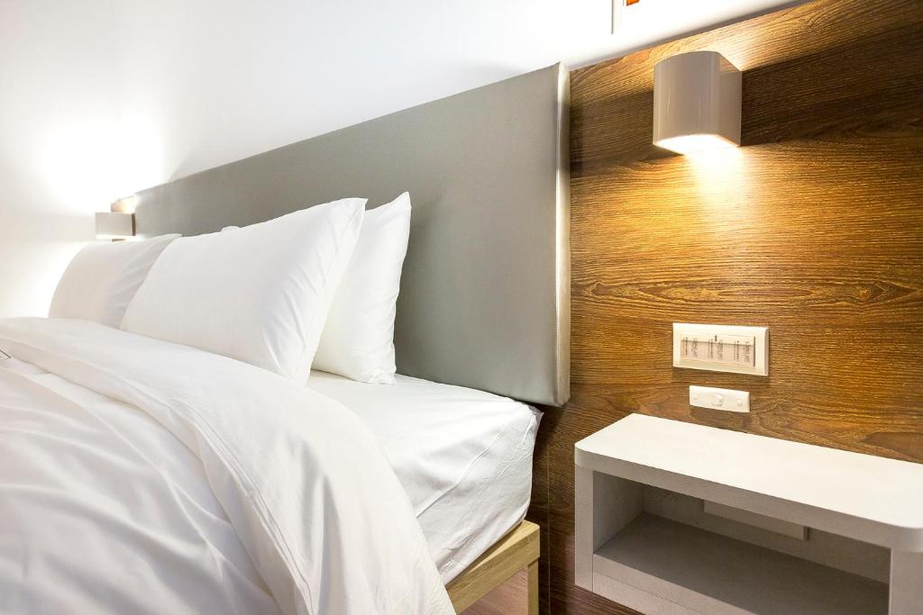 Postel nebo postele na pokoji v ubytování Greatt Hotel