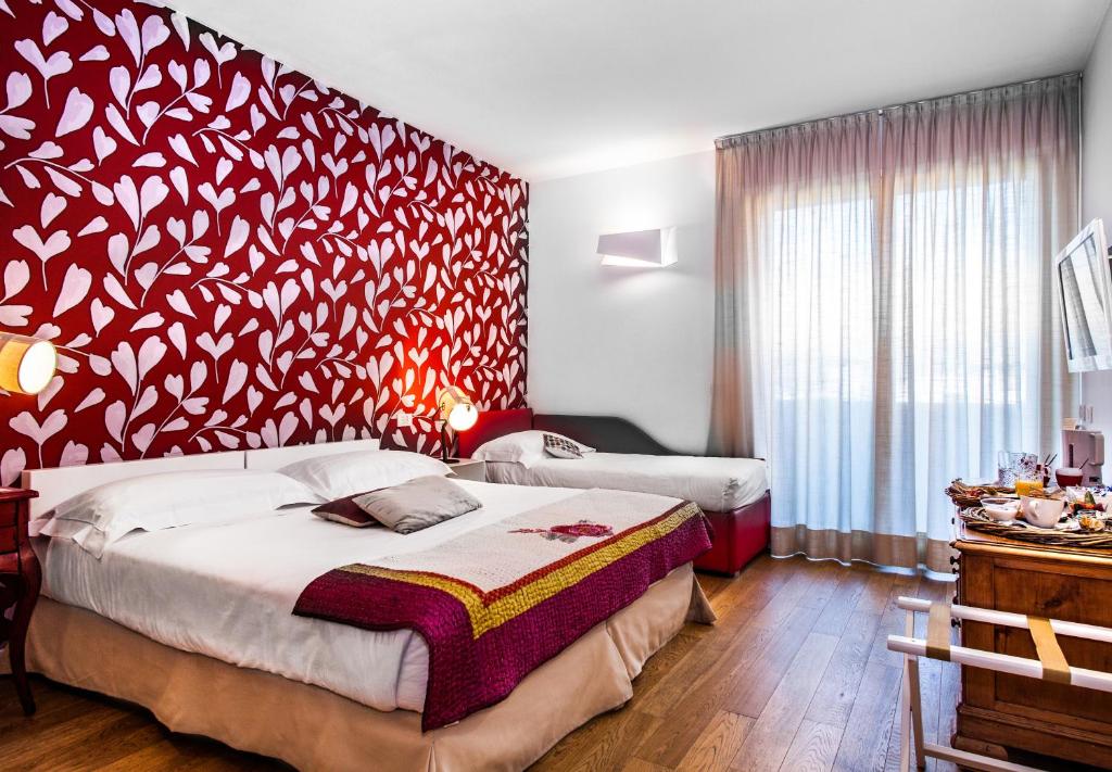 Postel nebo postele na pokoji v ubytování Spluga Sosta & Hotel