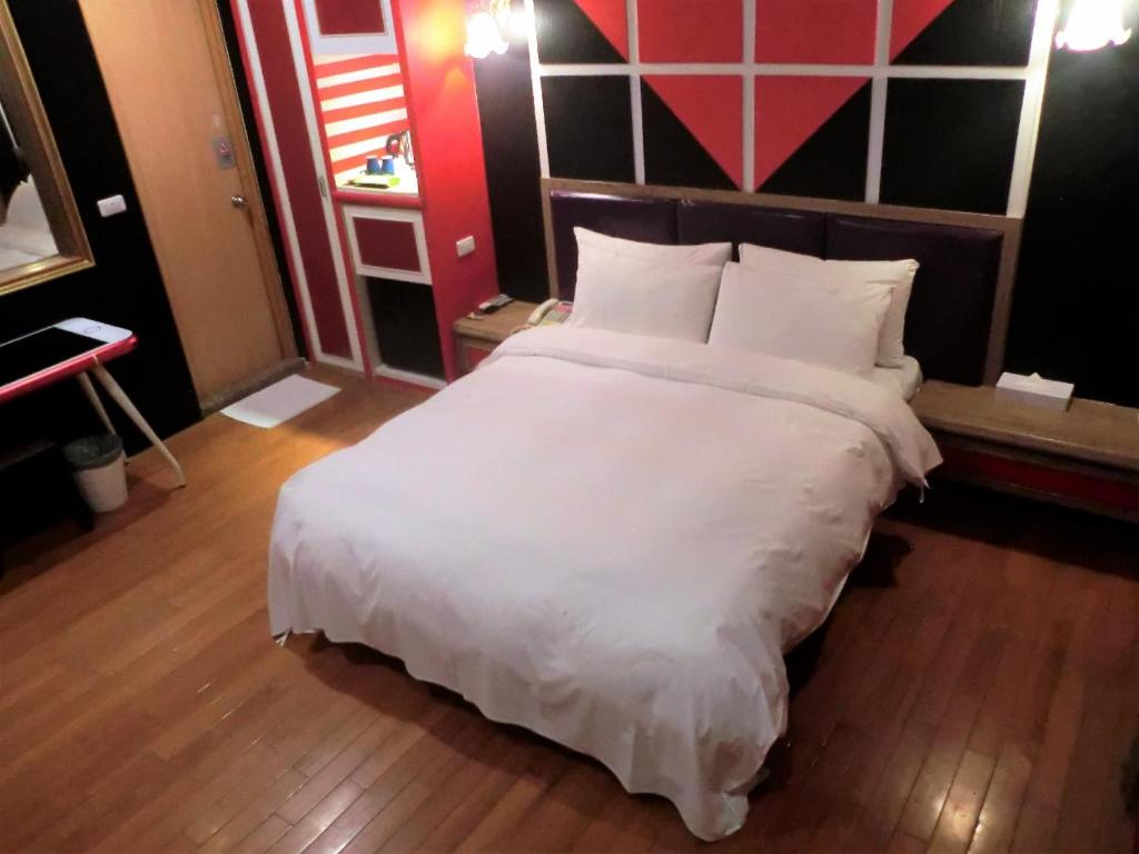 Postel nebo postele na pokoji v ubytování Guest Motel-Zhubei