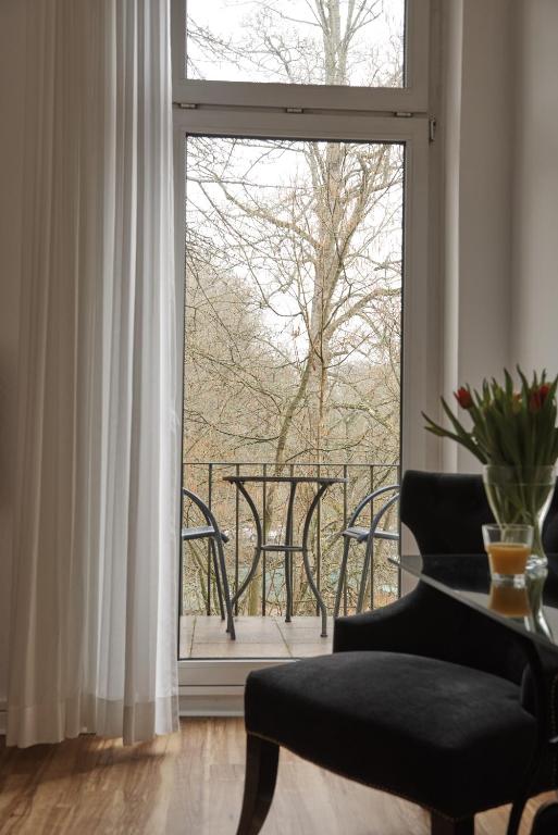 a room with a window with a view of a balcony at Hotel Burgfeld in Kassel