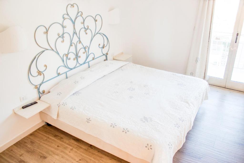 Postel nebo postele na pokoji v ubytování Olbia City Hotel