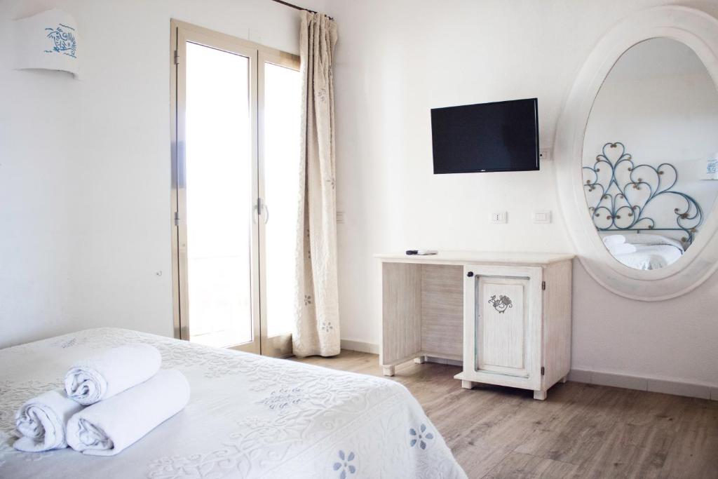 Postel nebo postele na pokoji v ubytování Olbia City Hotel