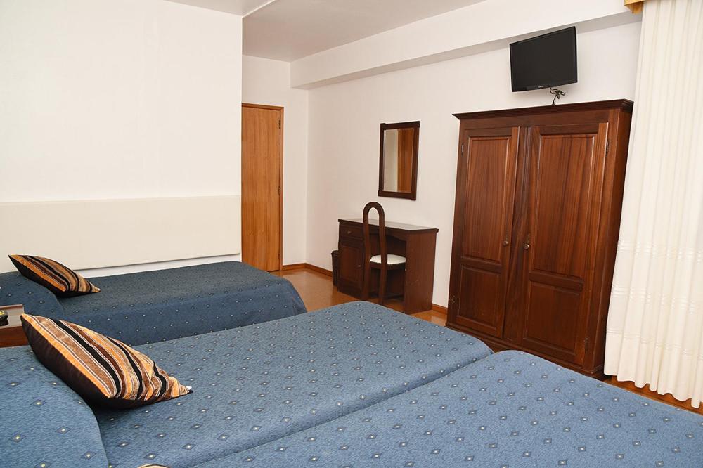 Postel nebo postele na pokoji v ubytování Hotel Val Flores