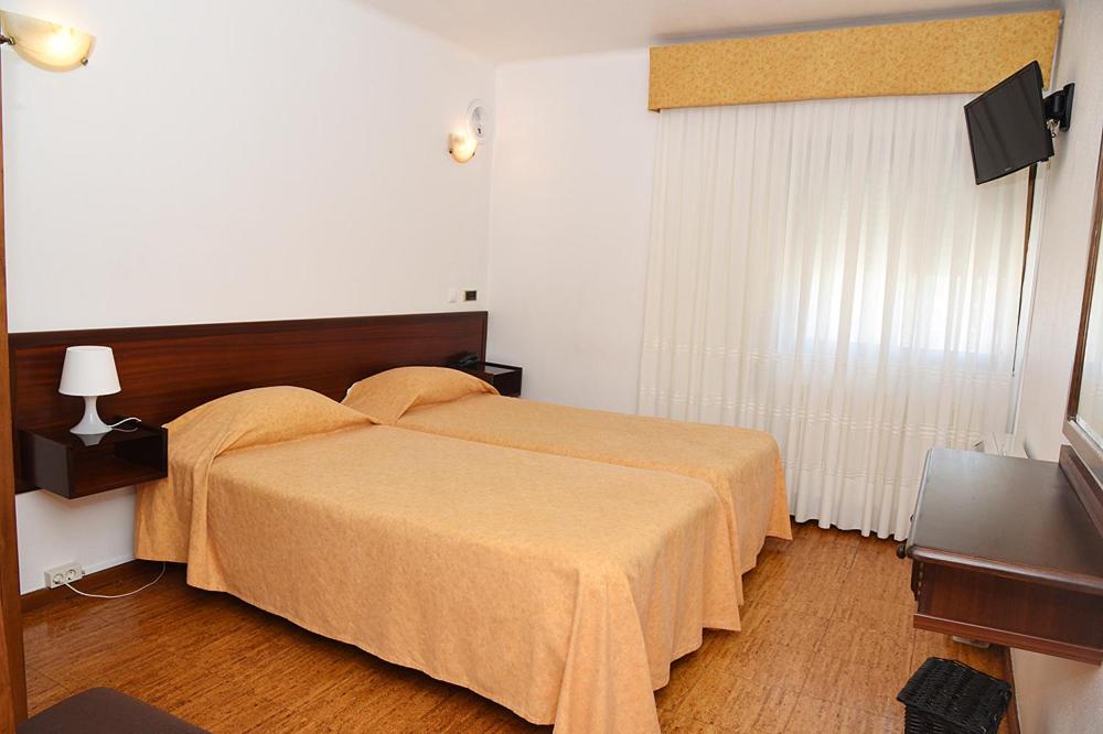 Postel nebo postele na pokoji v ubytování Hotel Val Flores