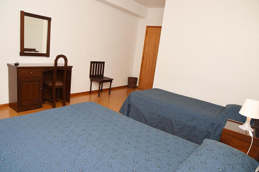 Postel nebo postele na pokoji v ubytování Hotel Val Flores