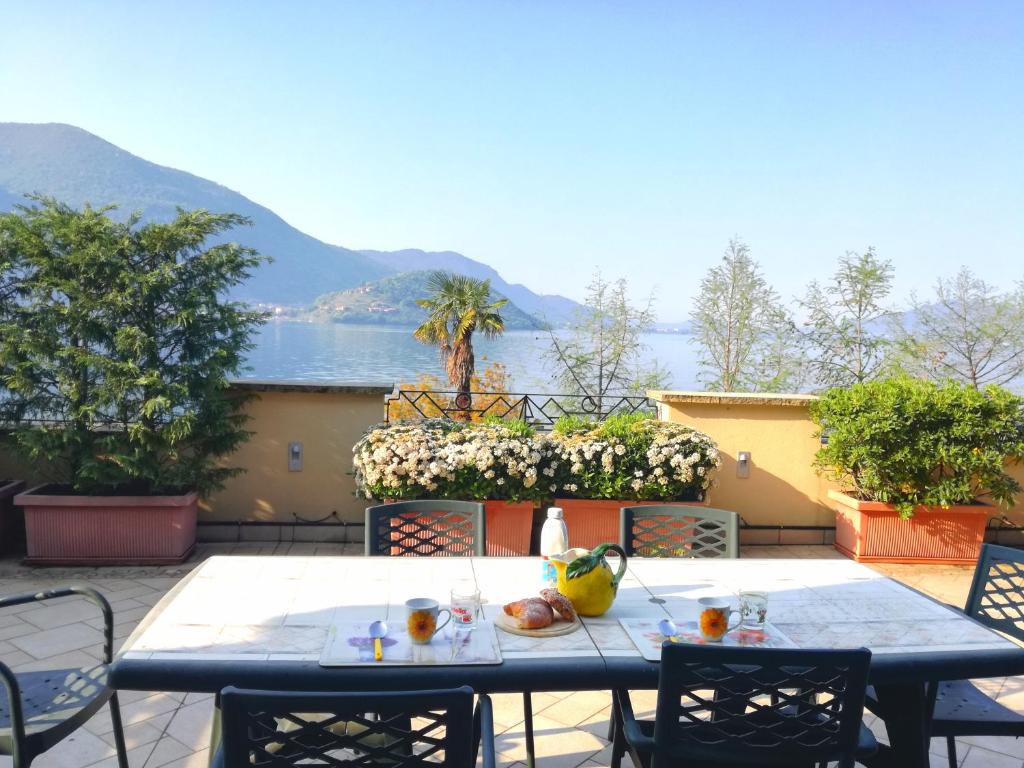 a table on a patio with a view of the water at Appartamento "La Collina" in Monte Isola