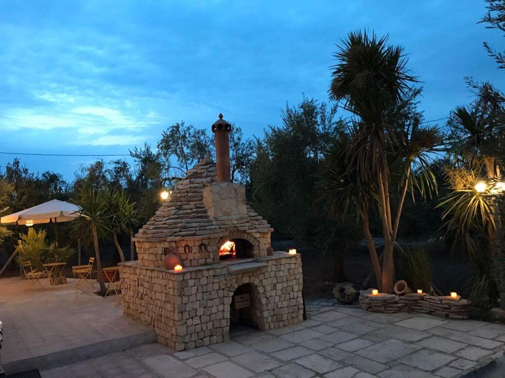 a stone fireplace with a fire inside of it at Dedo B&B in Terlizzi