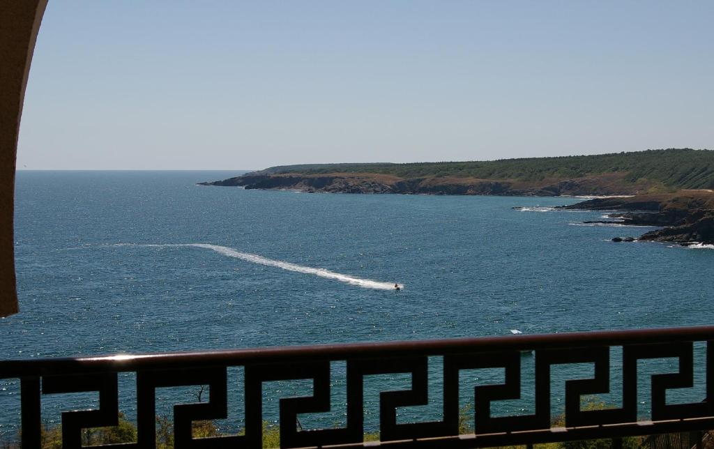 a boat in a large body of water at Apart Hotel Apolonia Palace in Sinemorets