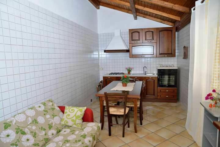 a kitchen with a couch and a table in a room at Isola sul mare breve il centro in Castellammare del Golfo