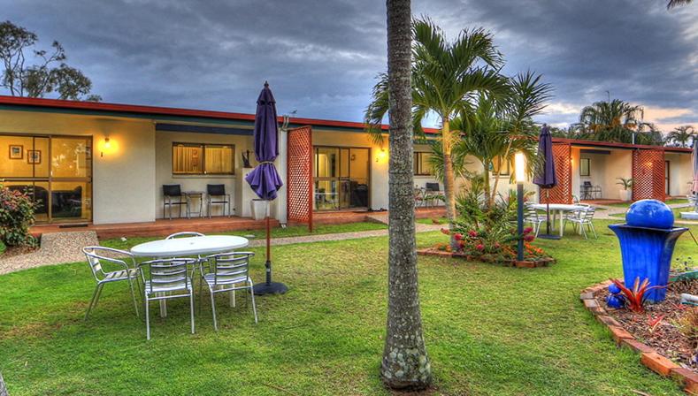 une cour avec une table et des chaises ainsi qu'une maison dans l'établissement Sunlover Lodge, à Kinka