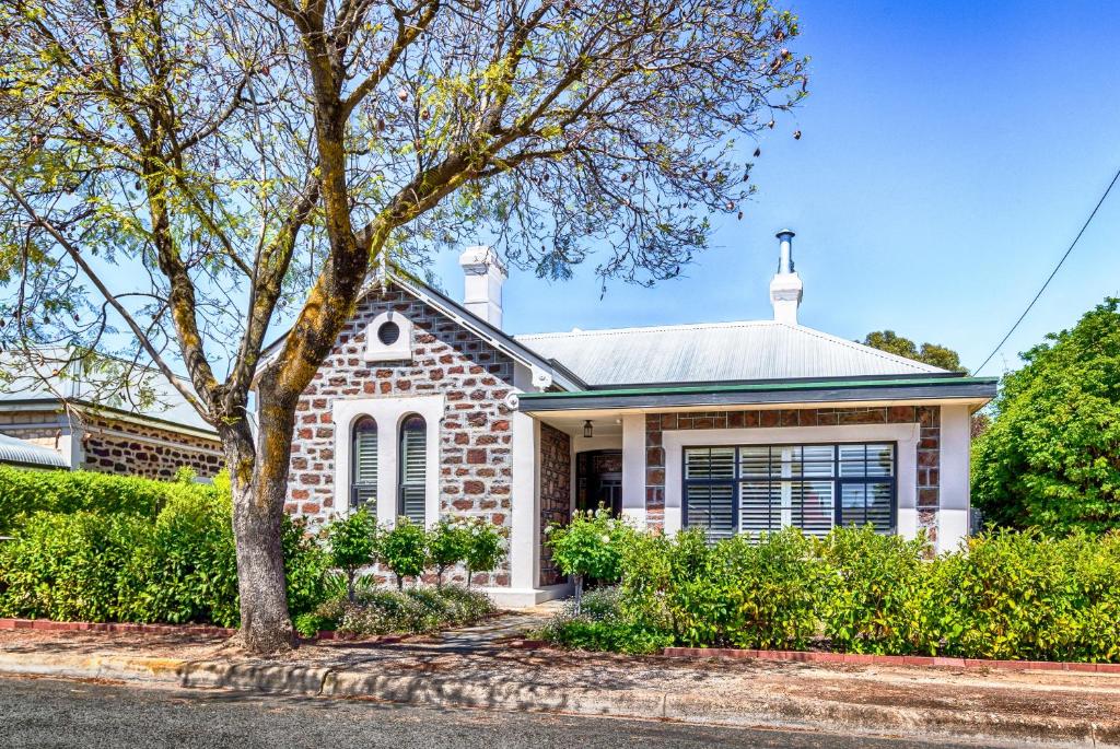 a brick house with a tree in front of it at Barossa Valley View Guesthouse in Tanunda