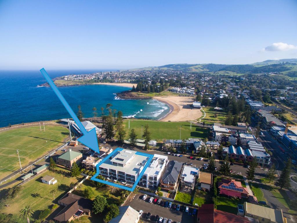 a large blue and white boat on a body of water at Bluewater Apartments in Kiama