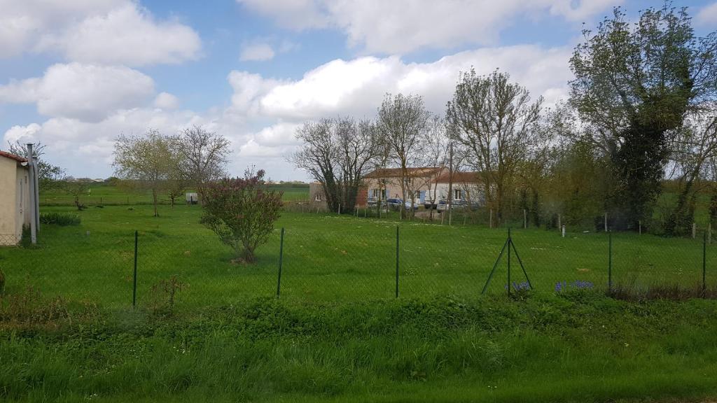 a field with a fence in the grass at Des Km à La Ronde in La Ronde