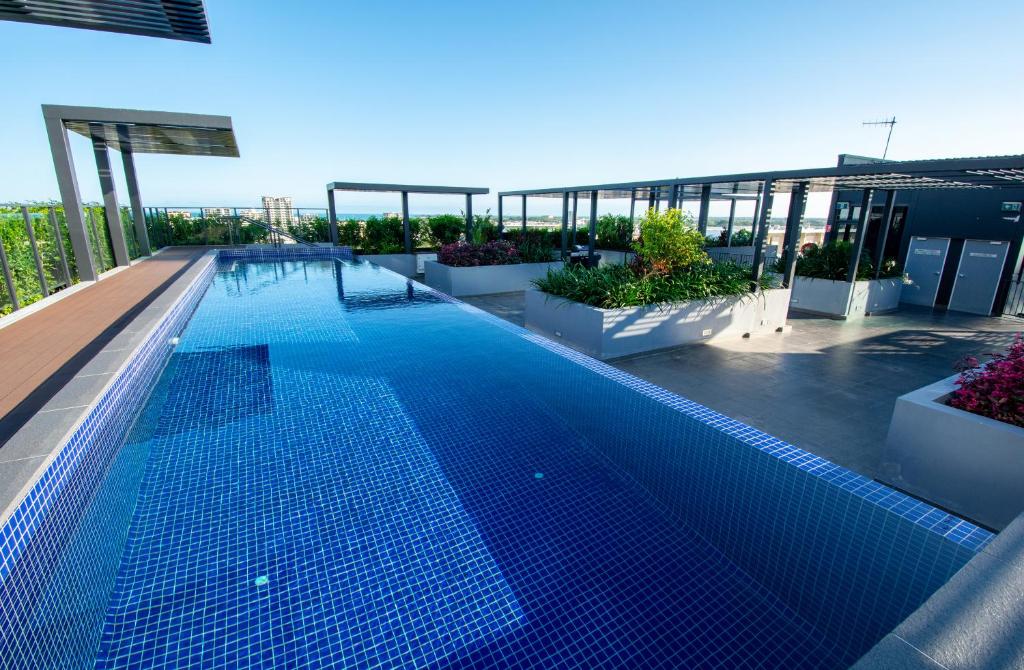 a large swimming pool on the roof of a building at Magnum Serviced Apartments in Darwin