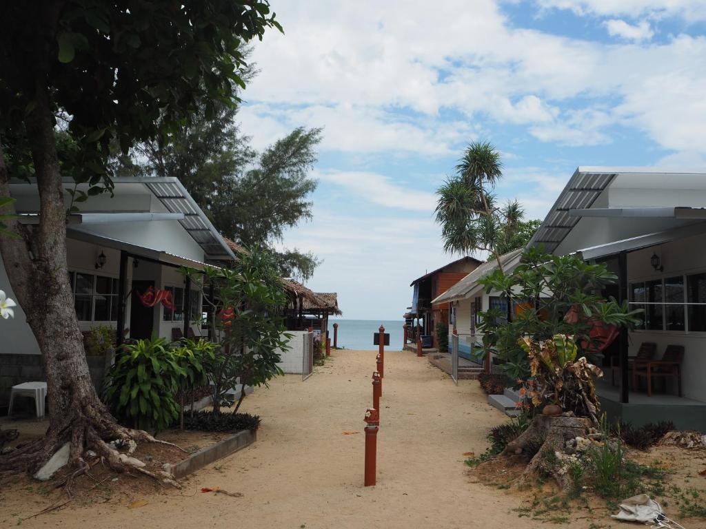 a street with buildings and the ocean in the background at Bluesky Beach Bungalows in Ko Lanta