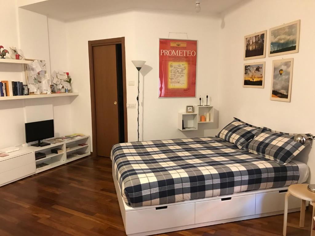 a bedroom with a bed and a tv in it at New Studio Città Studi in Milan