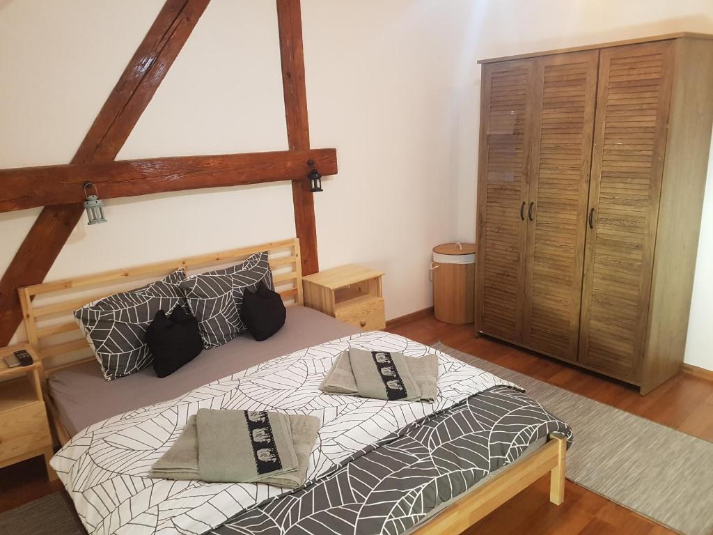 a bedroom with a bed with two pillows on it at Apartament Eminescu 1 in Mediaş