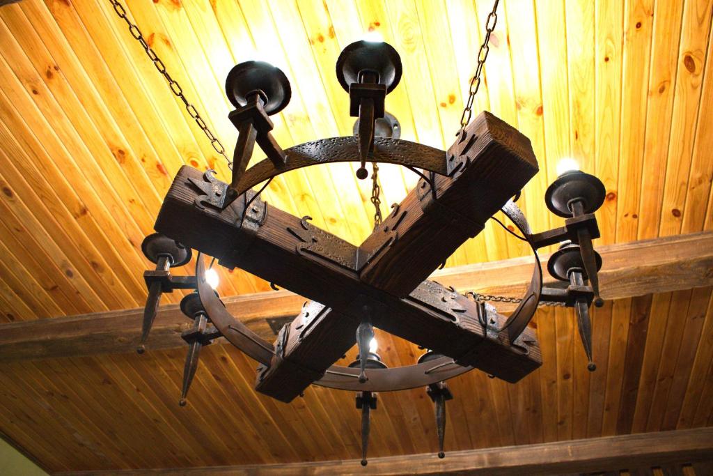 a wooden chandelier hanging from a ceiling at Smotrytska Vezha in Kamianets-Podilskyi