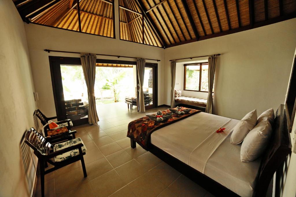 a bedroom with a large bed in a room at Bali Dream House in Amed