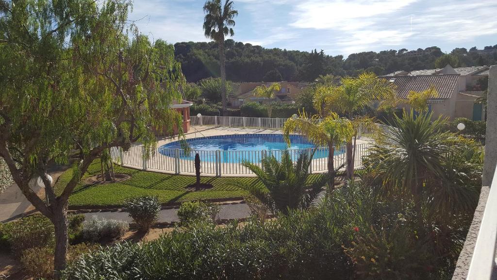 basen w ogrodzie z drzewami i płotem w obiekcie tahiti parc maisonnette 6 pers 2 chambre w mieście Le Lavandou