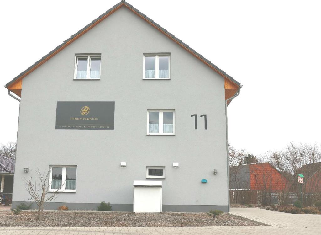 a white house with the number on it at Penny Pension in Groß Sisbeck