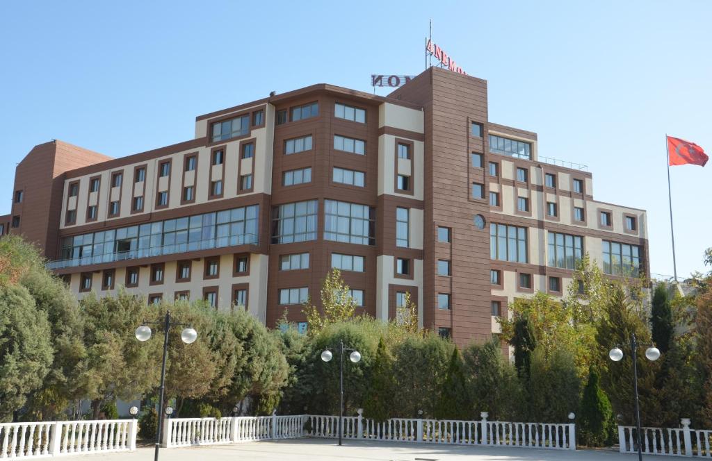 a building with a flag on top of it at Anemon Grand Manisa in Manisa