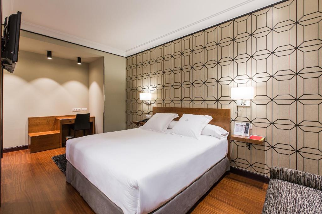Postel nebo postele na pokoji v ubytování Hotel Carlton