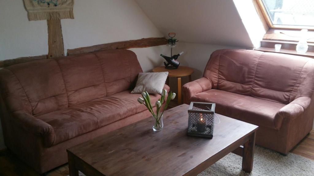 a living room with a couch and a coffee table at Das Alte Kneipchen in Oberhambach