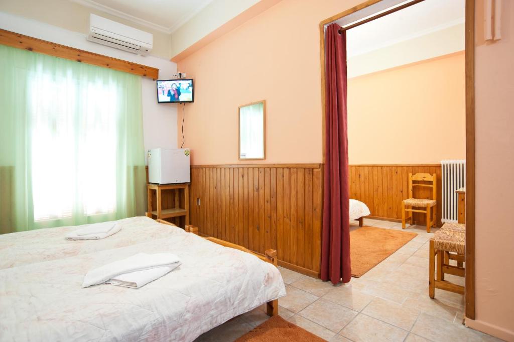 Postel nebo postele na pokoji v ubytování Hotel Athina