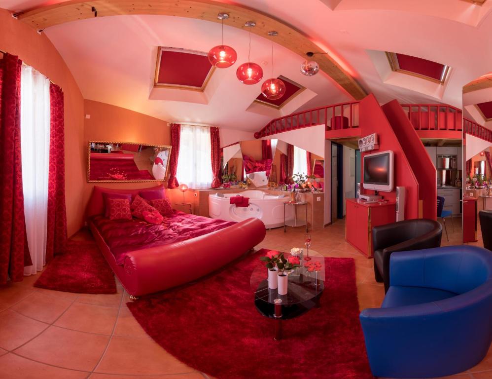 a living room with a red couch and a tv at Loveroom in Interlaken