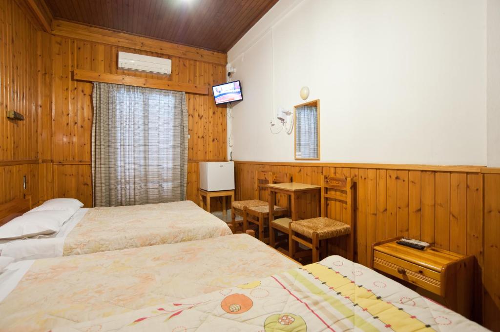 Postel nebo postele na pokoji v ubytování Hotel Athina