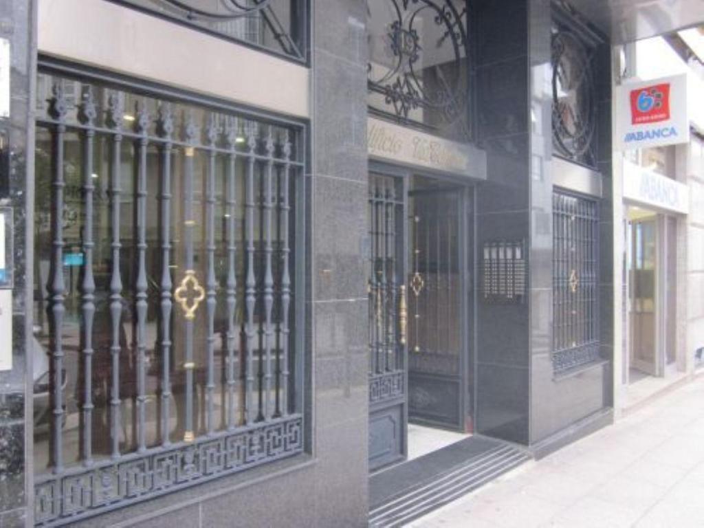 deux photos d'un bâtiment avec portes en fer forgé dans l'établissement Torre Center, à Saint-Jacques-de-Compostelle