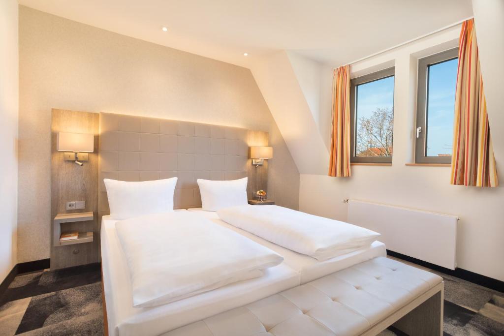 Postel nebo postele na pokoji v ubytování Hotel Krämerbrücke Erfurt