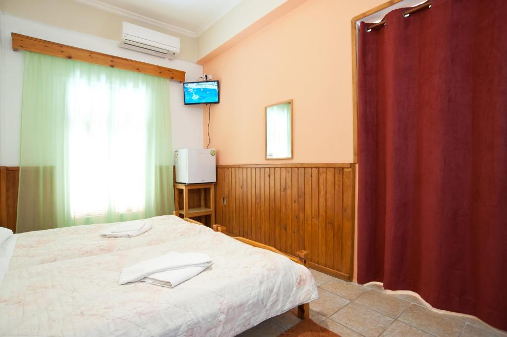 Postel nebo postele na pokoji v ubytování Hotel Athina