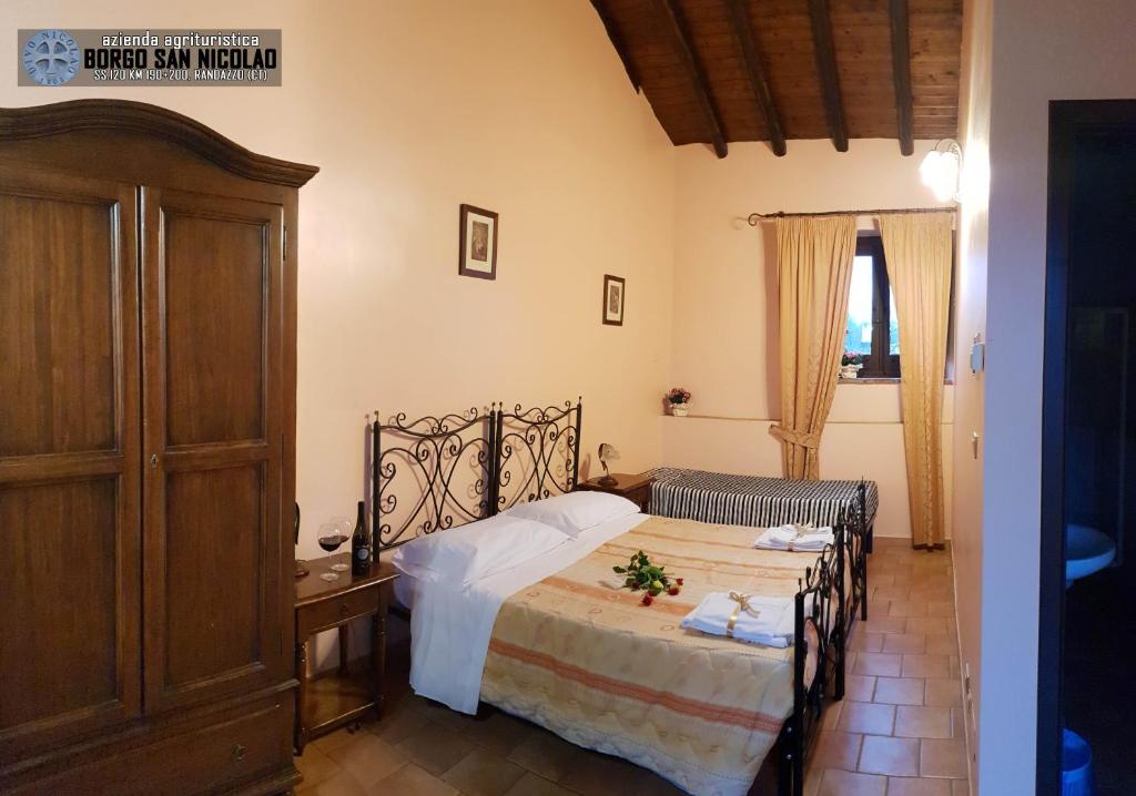 Postel nebo postele na pokoji v ubytování Agriturismo Borgo San Nicolao