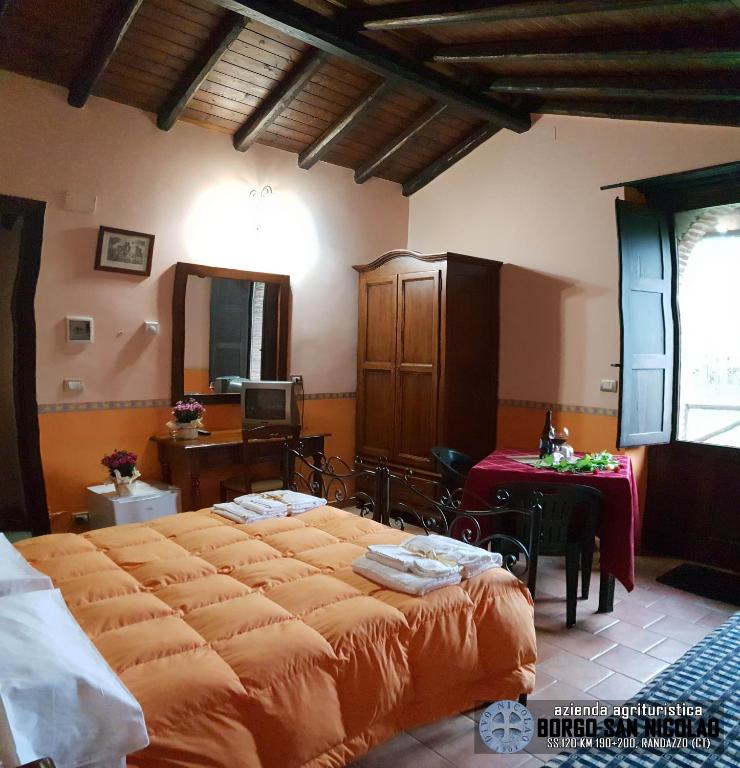 Postel nebo postele na pokoji v ubytování Agriturismo Borgo San Nicolao