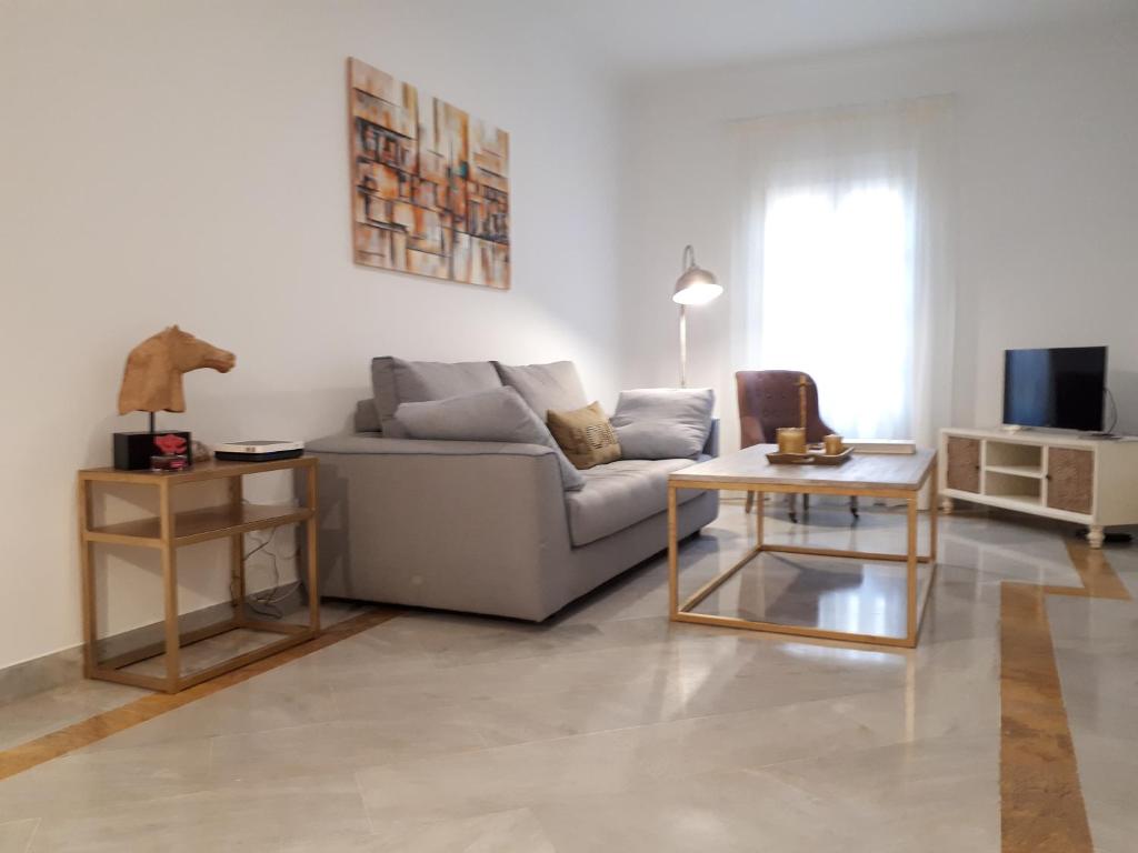 a living room with a couch and a table at REGINA apartment in Seville