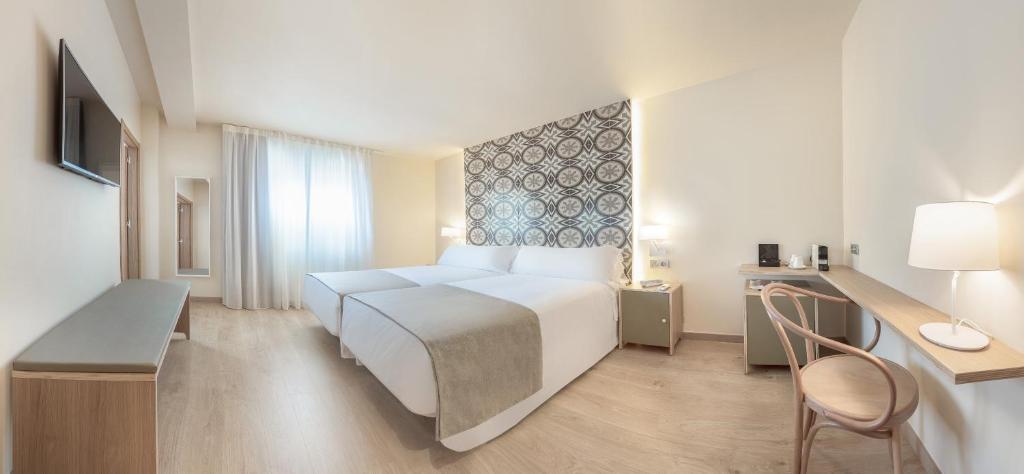 Postel nebo postele na pokoji v ubytování Gastrohotel Boutique RH Canfali
