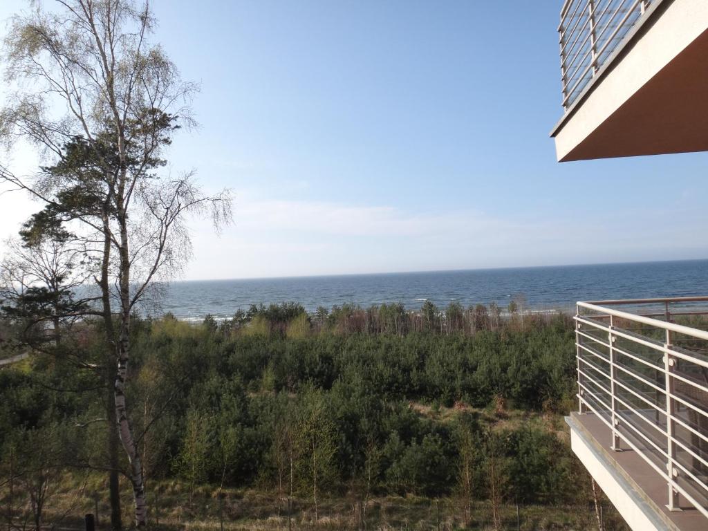 a view of the ocean from the balcony of a house at Porta Balticum in Dziwnówek