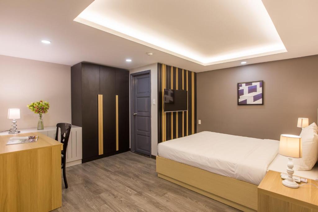 Giường trong phòng chung tại Binh Duong Resident Hotel